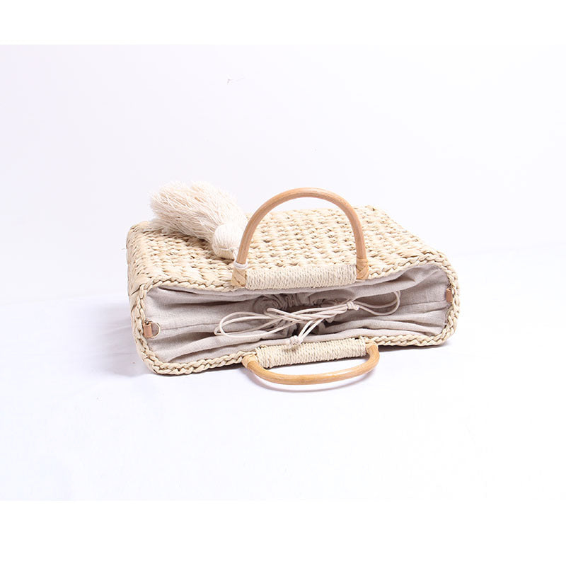 Handcrafted straw shoulder bag with decorative tassel pendant Bowlift
