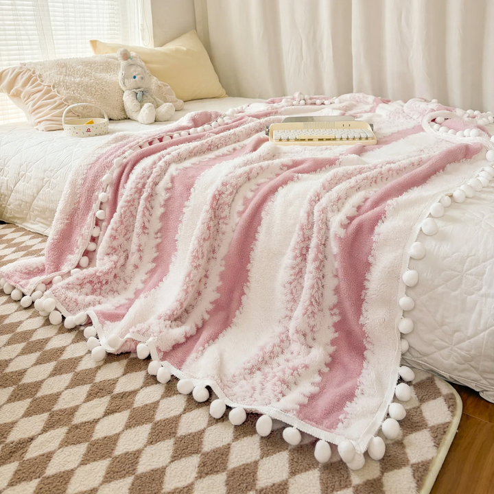 Structured throw blanket with pom-pom details