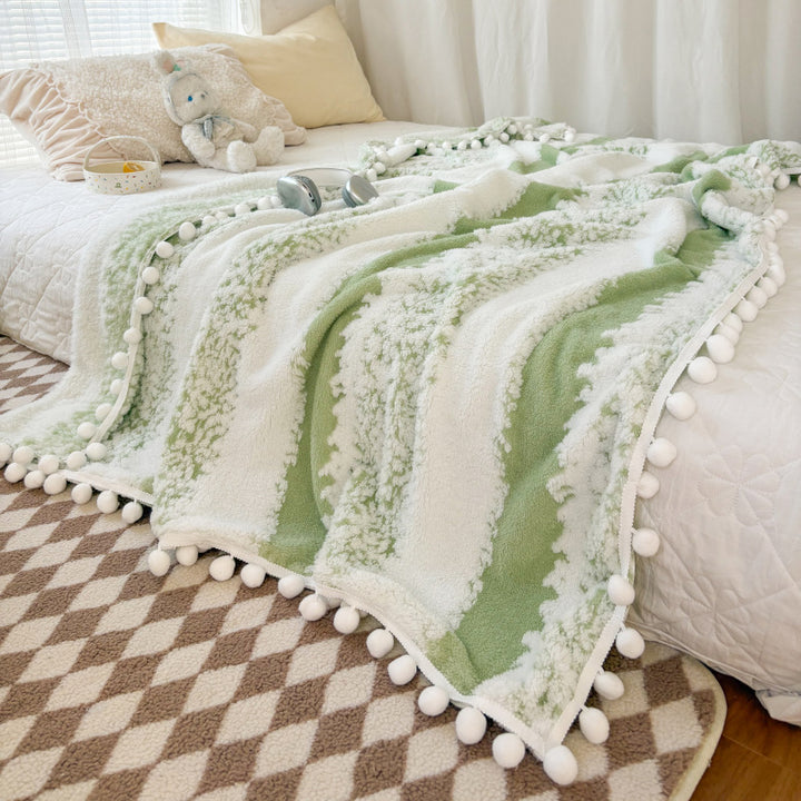 Structured throw blanket with pom-pom details