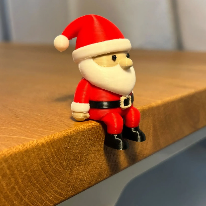 Miniature Santa Claus figure, sitting