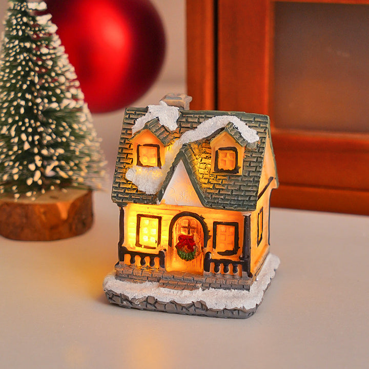 Illuminated Christmas cottage made of resin