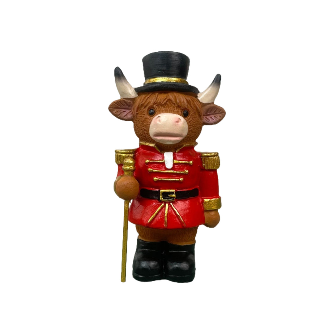 Decorative nutcracker and highland cattle figures made of resin