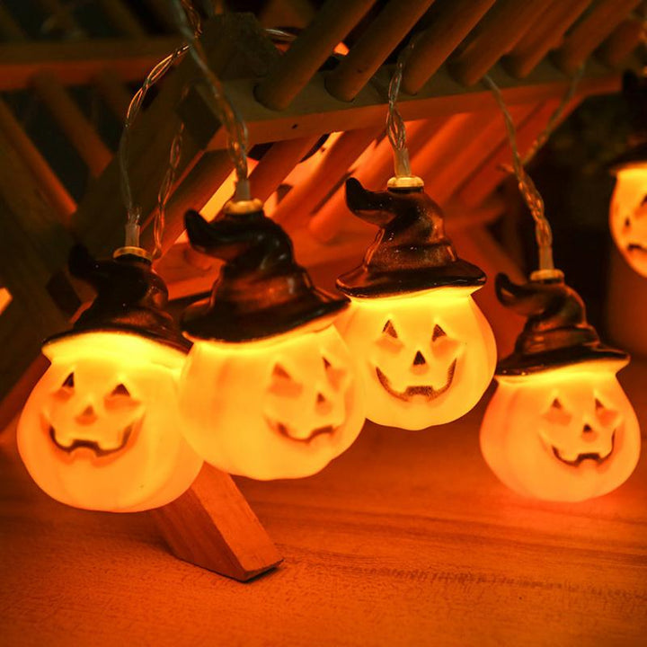 Glowing pumpkin garland Halloween with witch hats | Bowlift