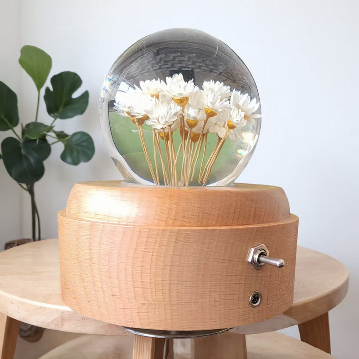 Crystal ball music box with rotating base and dried flowers