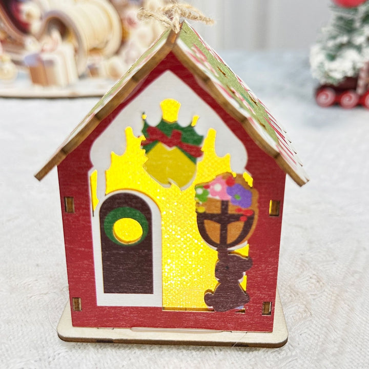Illuminated wooden house for festive table decoration
