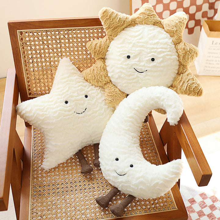 Decorative cuddle cushions with moon, star, and sun motif