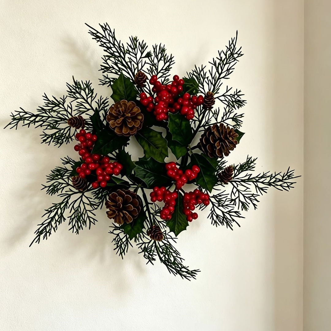 Christmas candle wreath with pine cones and red berries