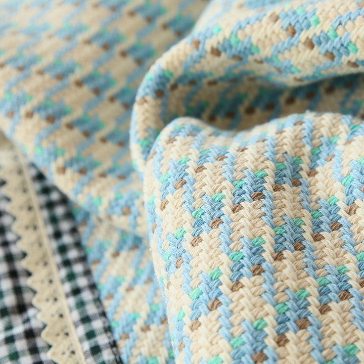 Handwoven breathable mattress topper with checkered decorative ribbon