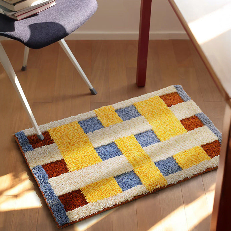Rectangular tufted door mat with geometric block pattern and non-slip backing Bowlift