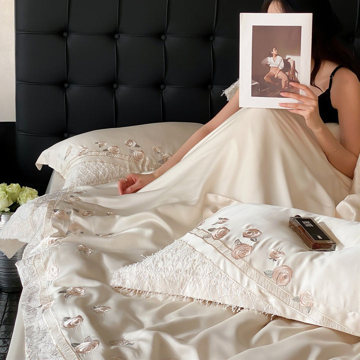 Luxurious satin bedding set with rose embroidery and fringed trim