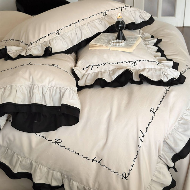 Luxurious bedding set with ruffle and text embroidery