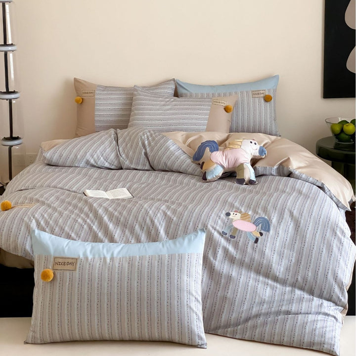 Children's bedding set with embroidered car applique and pompom detail