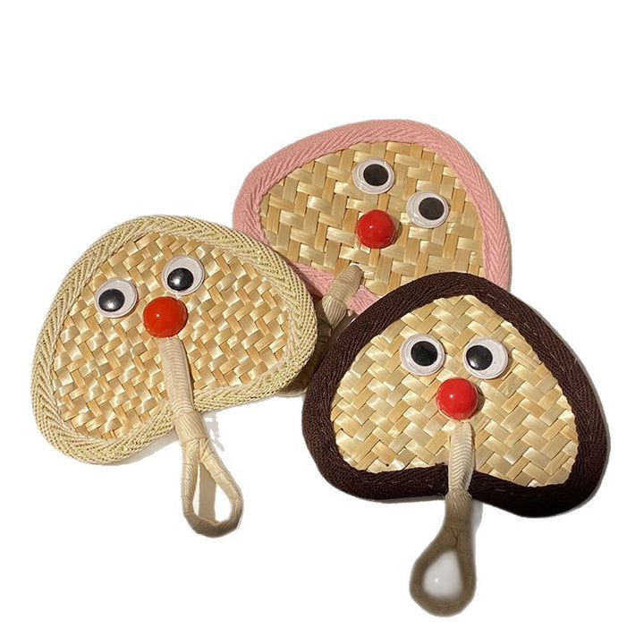 Handcrafted fan with playful face motif Bowlift