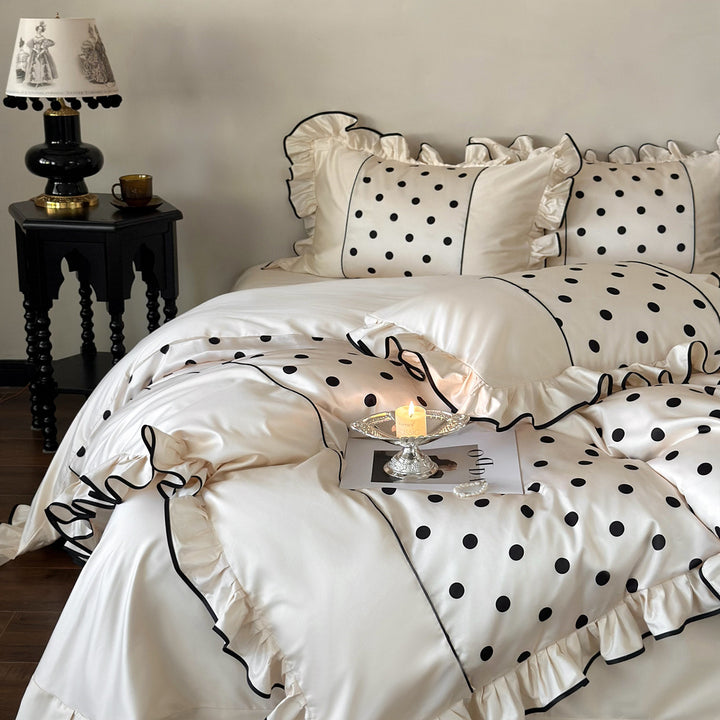 Luxurious satin bedding set with polka dot design, ruffle and contrast piping