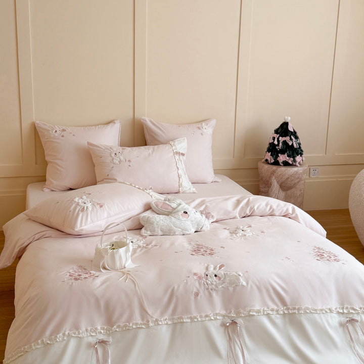 Romantic bedding set with ruffles and embroidered bunny motifs