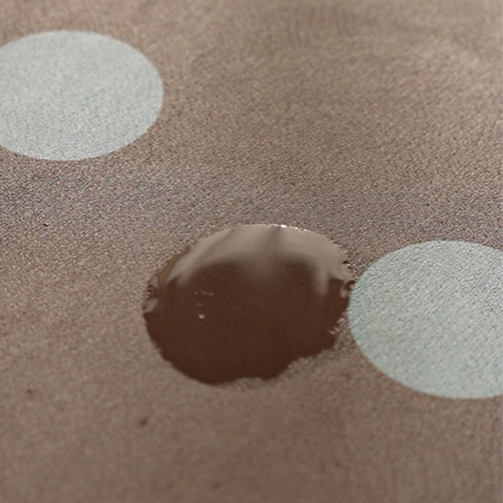 Wipeable placemat made of PVC with large polka dot pattern and non-slip backing Bowlift