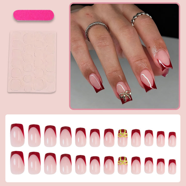 Artificial nail set with elegant red tips and refined bow decorations Bowlift