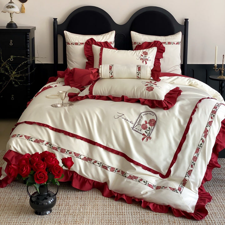 Satin bedding set with rose embroidery and ruffle trim