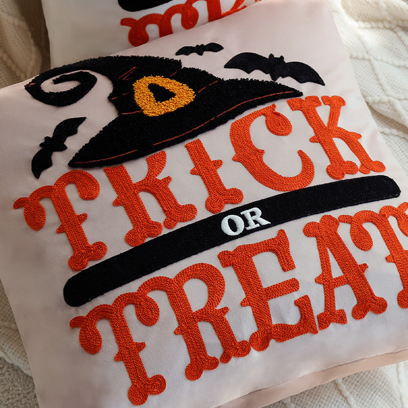 Square decorative cushion cover with witch hat appliqué and 'Trick or Treat' tufting Bowlift