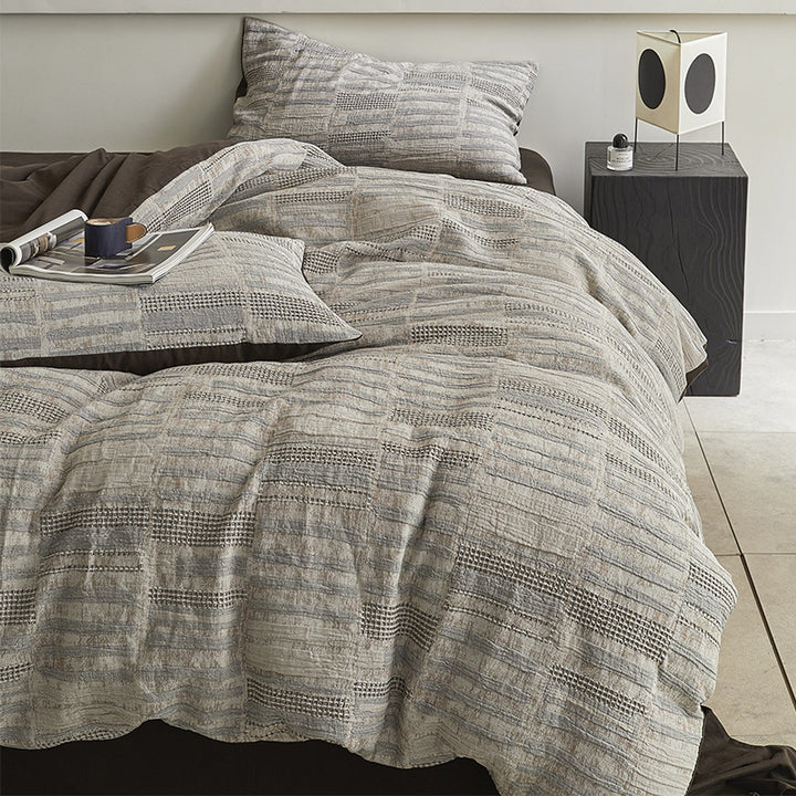 Quilted bed set with textured jacquard stripe design
