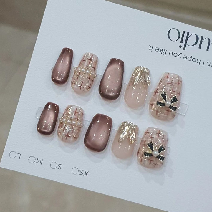 Artificial nails with glamorous bow accent