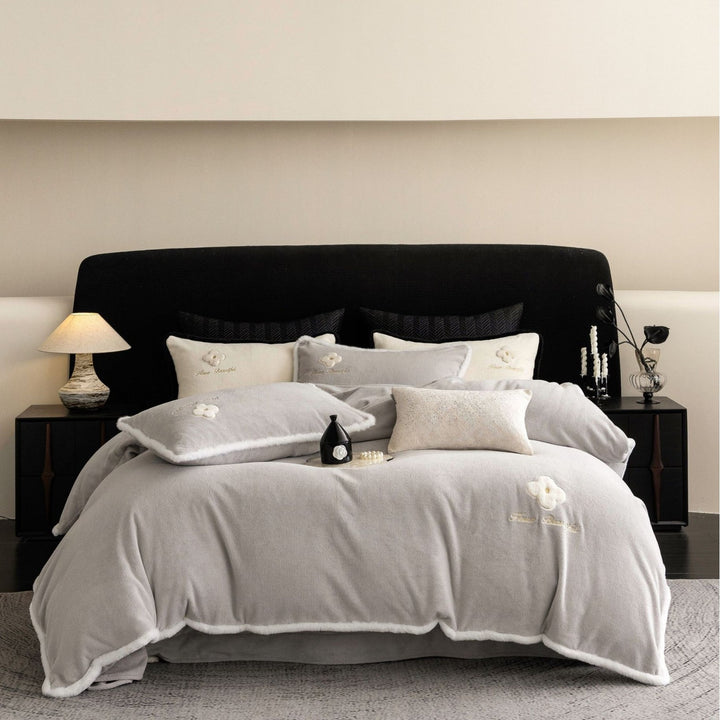 Cozy microfiber bedding set with plush surface, decorative flower appliqué and teddy trim