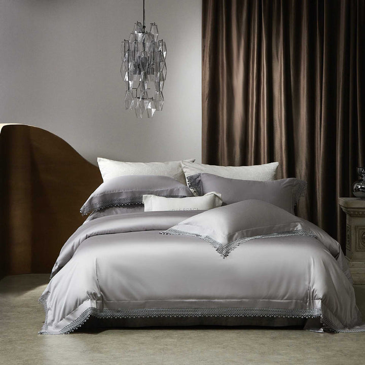 Romantic satin bedding set with delicate lace border and decorative pillowcases