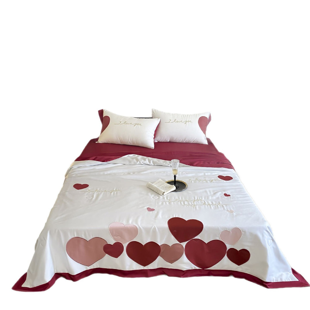 Bedding set with quilted heart appliqués and satin border