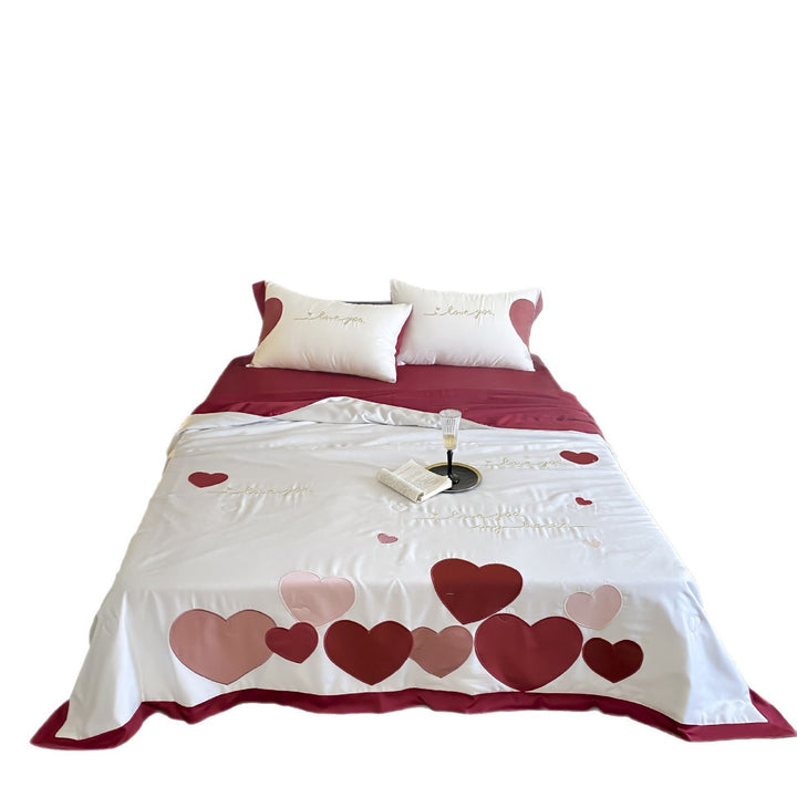 Bedding set with quilted heart appliqués and satin border