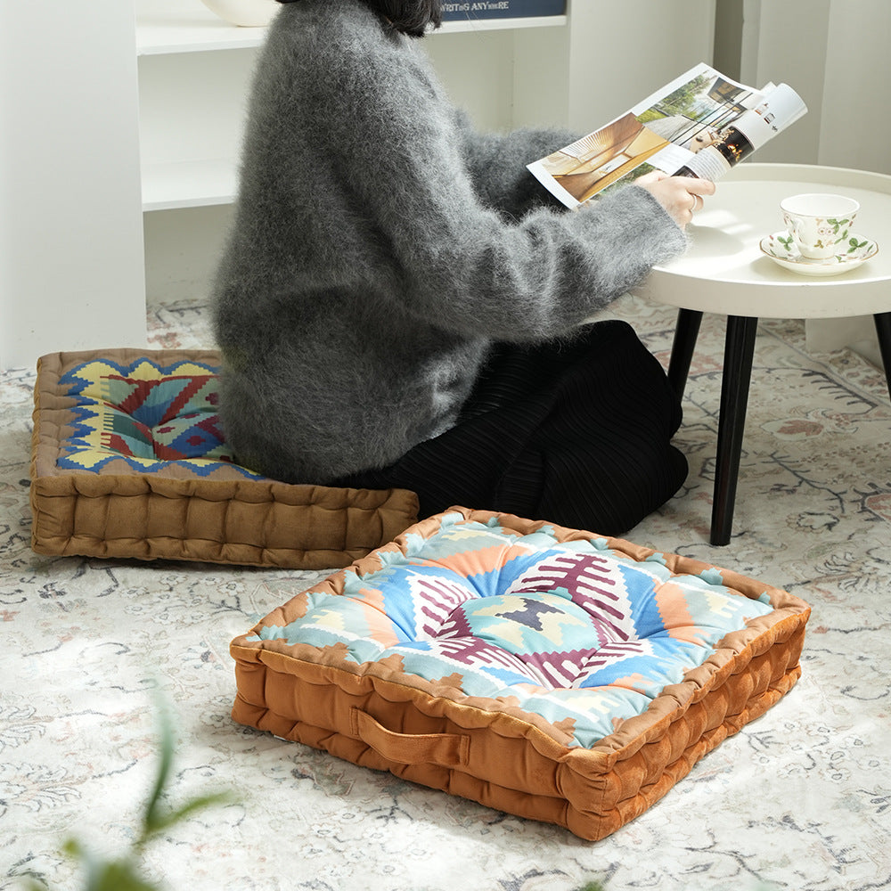 Square seat cushion with kilim-inspired pattern, quilted padding and carrying handle
