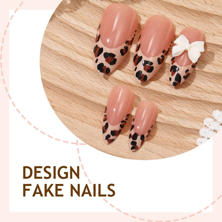 Artificial nail set with elegant leopard design and playful bow accents Bowlift