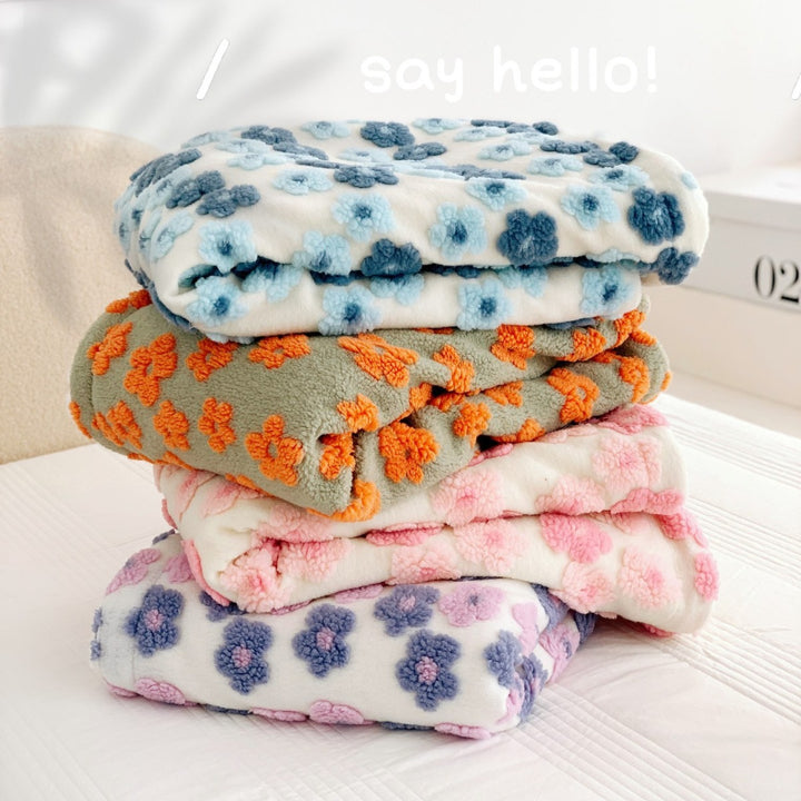 Cuddle blanket with teddy fleece surface and sherpa reversible lining, floral relief structure