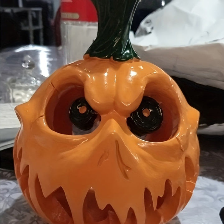 Ceramic pumpkin lantern with hollowed-out spooky face and tealight compartment