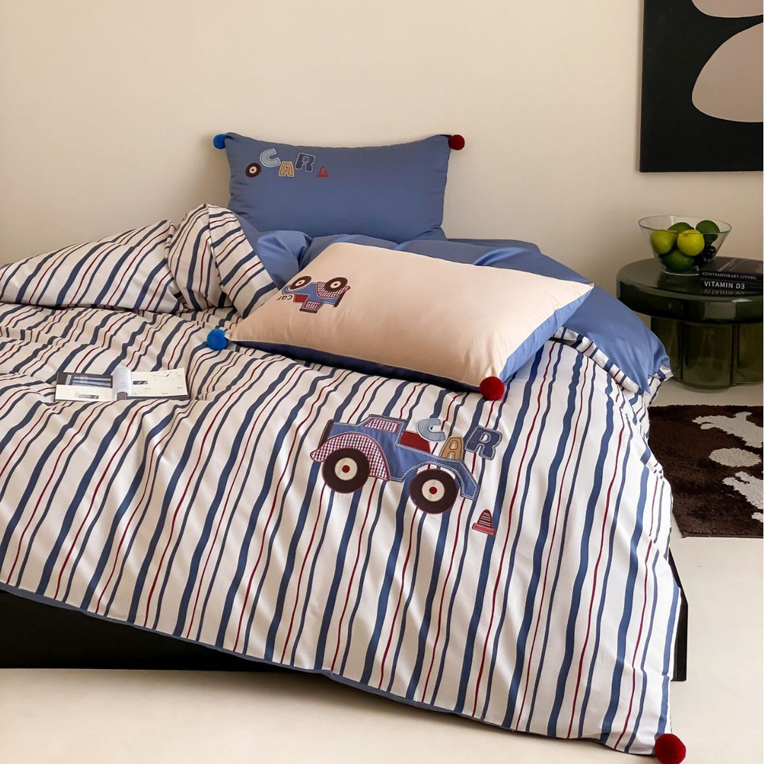 Children's bedding set with embroidered car applique and pompom detail