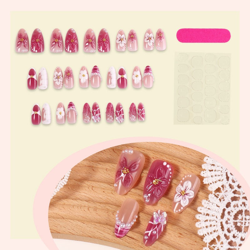 Artificial nail set with floral design and glitter accents Bowlift