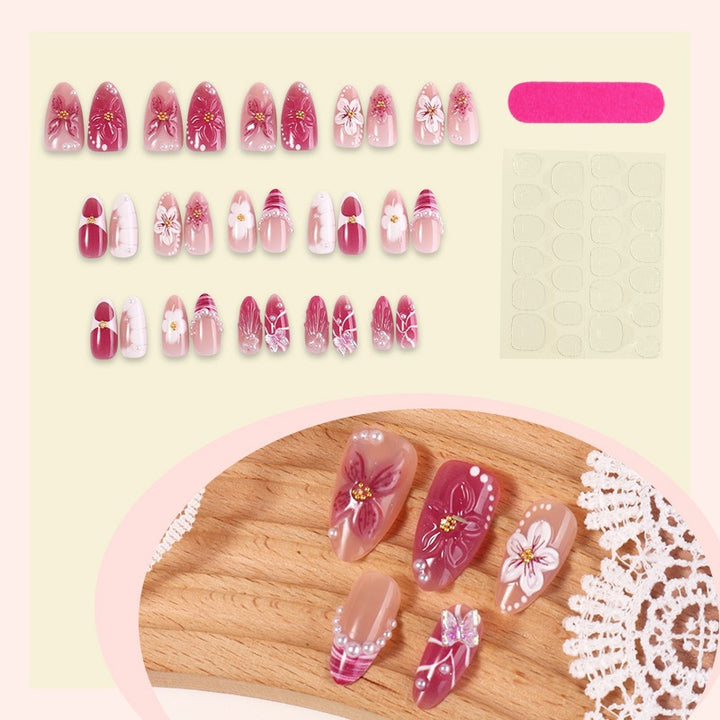 Artificial nail set with floral design and glitter accents Bowlift