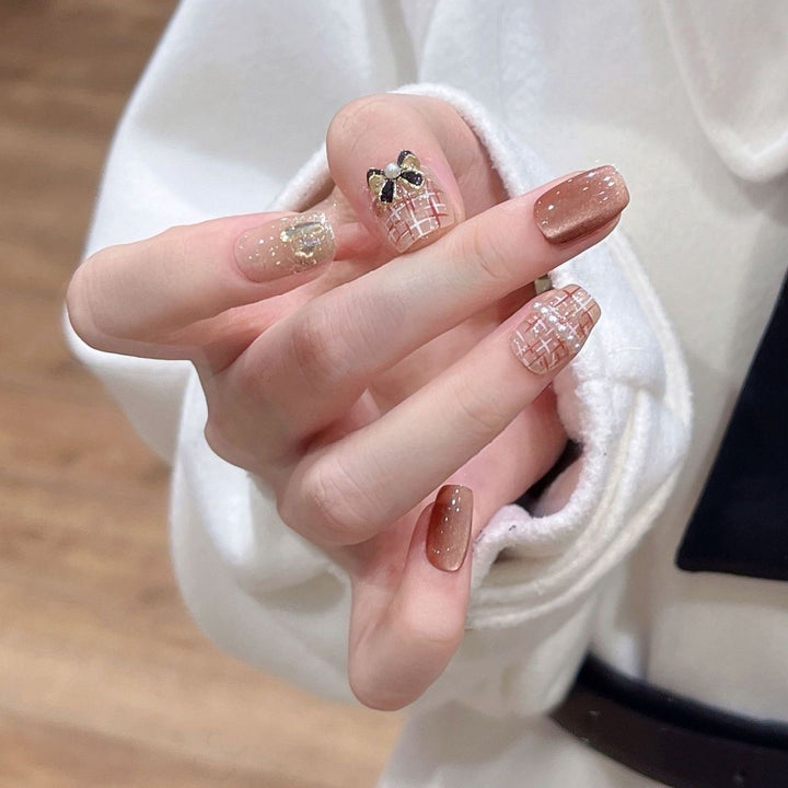 Artificial nails with glamorous bow accent