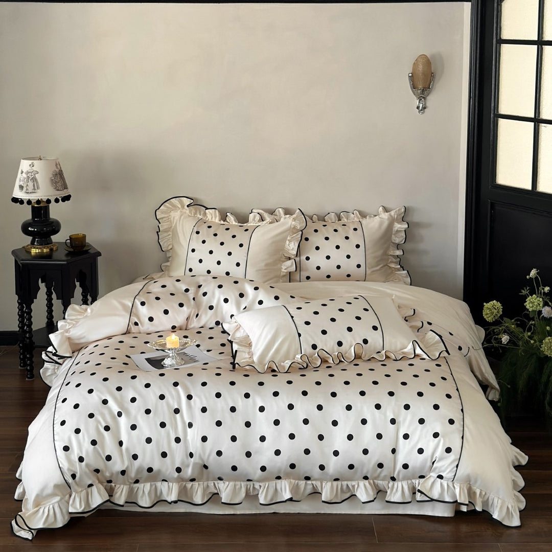 Luxurious satin bedding set with polka dot design, ruffle and contrast piping