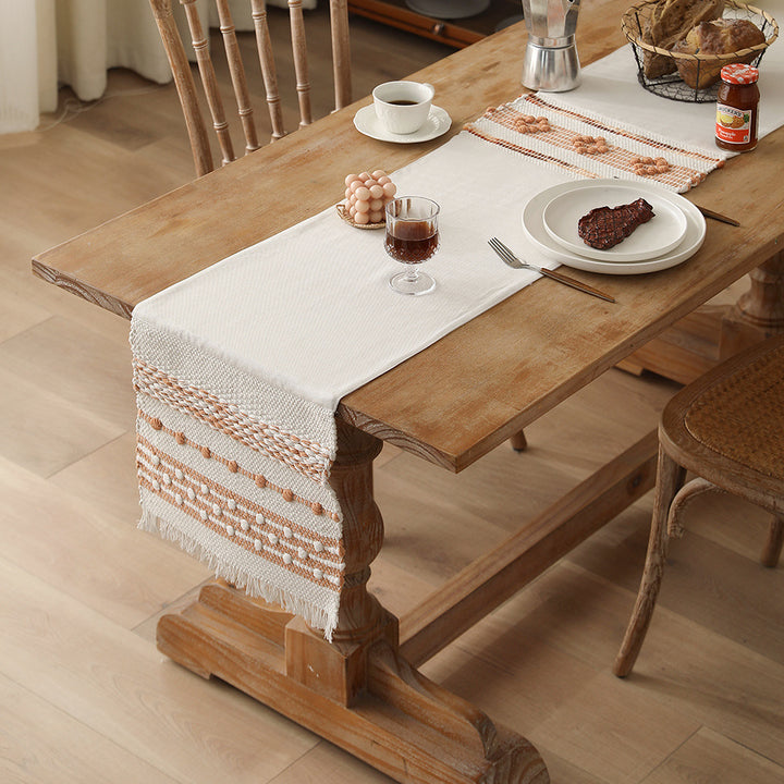 Woven cotton table runner with fringes and textured pattern Bowlift