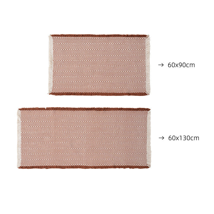 Handwoven cotton bath mat with herringbone pattern and fringes Bowlift