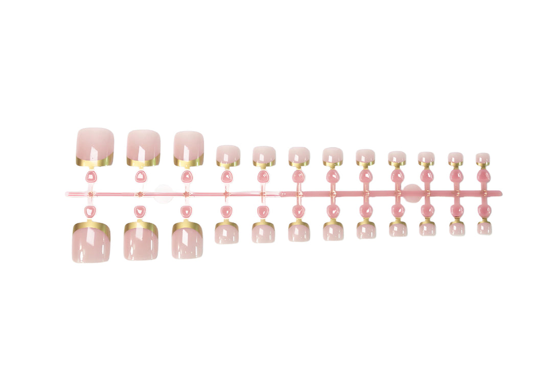 Toenail art set with elegant gold tips and delicate embellishments Bowlift
