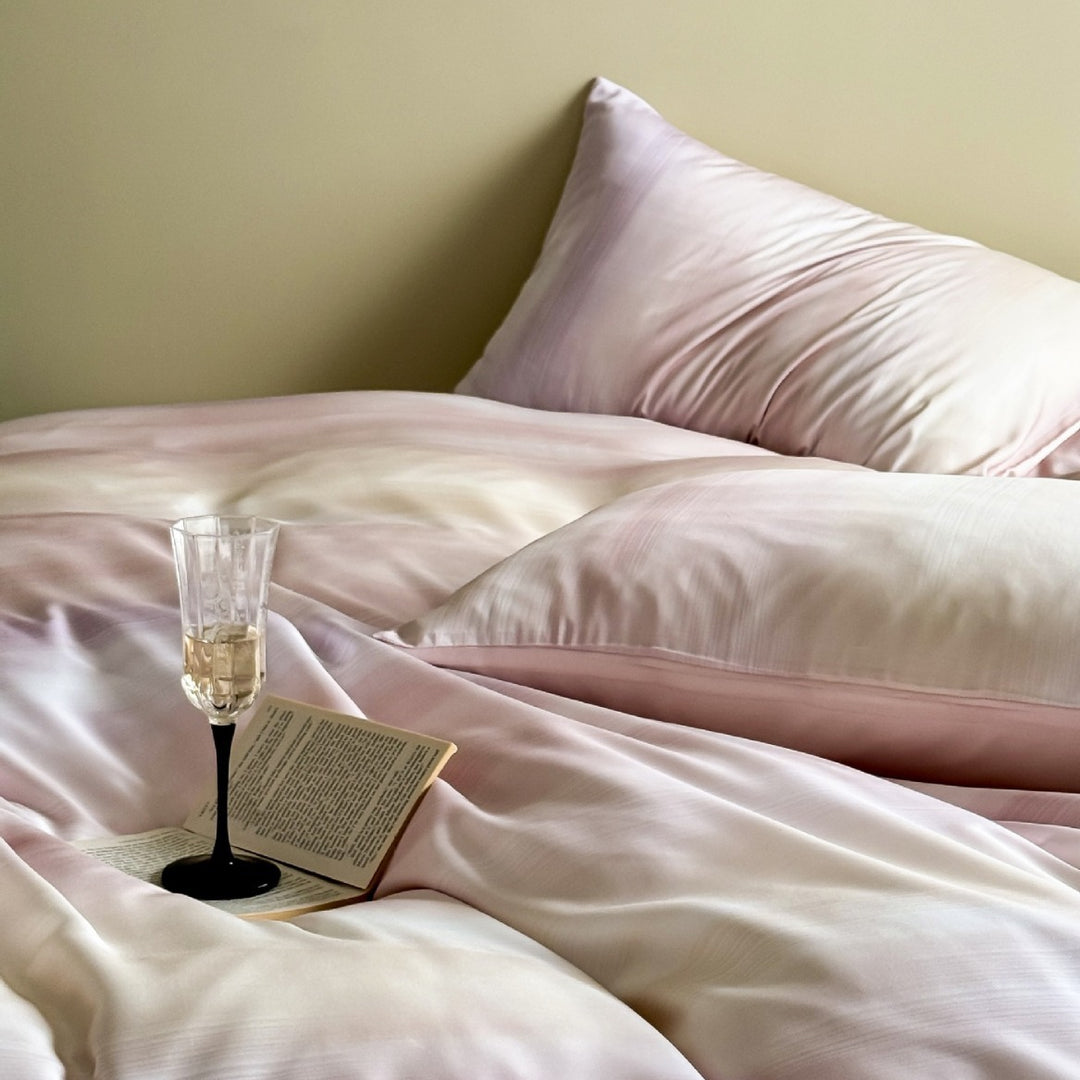 Luxurious Mako satin bedding set with gentle watercolor gradient and concealed hotel closure