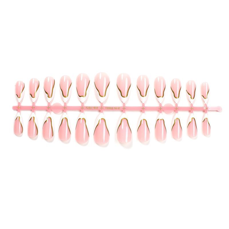 Artifical nail set with elegant gold trim and delicate pink Bowlift