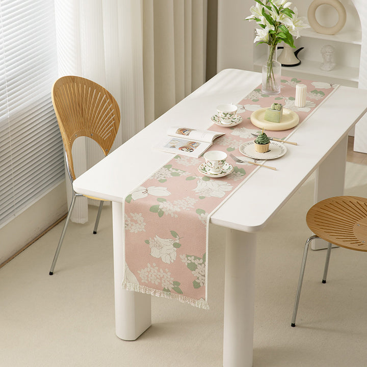 Woven table runner with floral jacquard pattern and fringed edge Bowlift