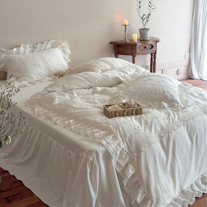 Vintage-inspired bedding set with ruffled trim and floral embroidery
