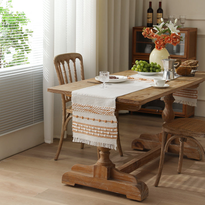 Woven cotton table runner with fringes and textured pattern Bowlift