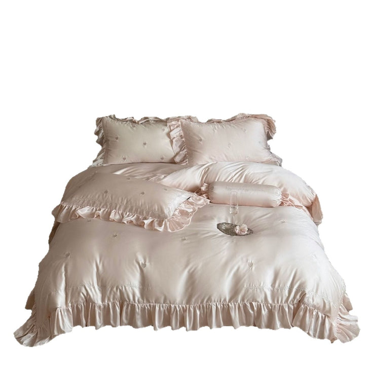 Satin bedding set with ruffle trim, quilted decorative cover and roll pillow