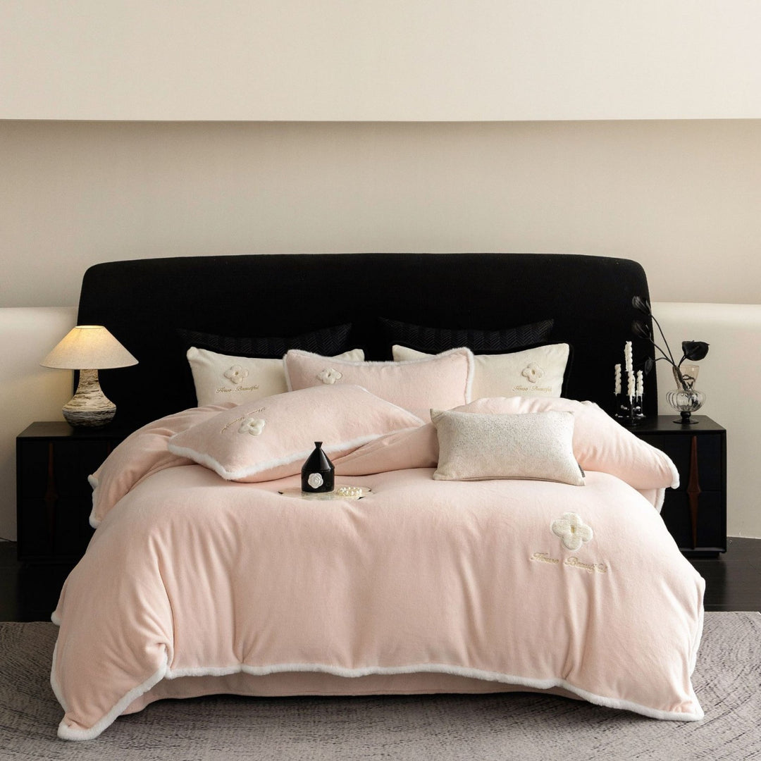 Cozy microfiber bedding set with plush surface, decorative flower appliqué and teddy trim