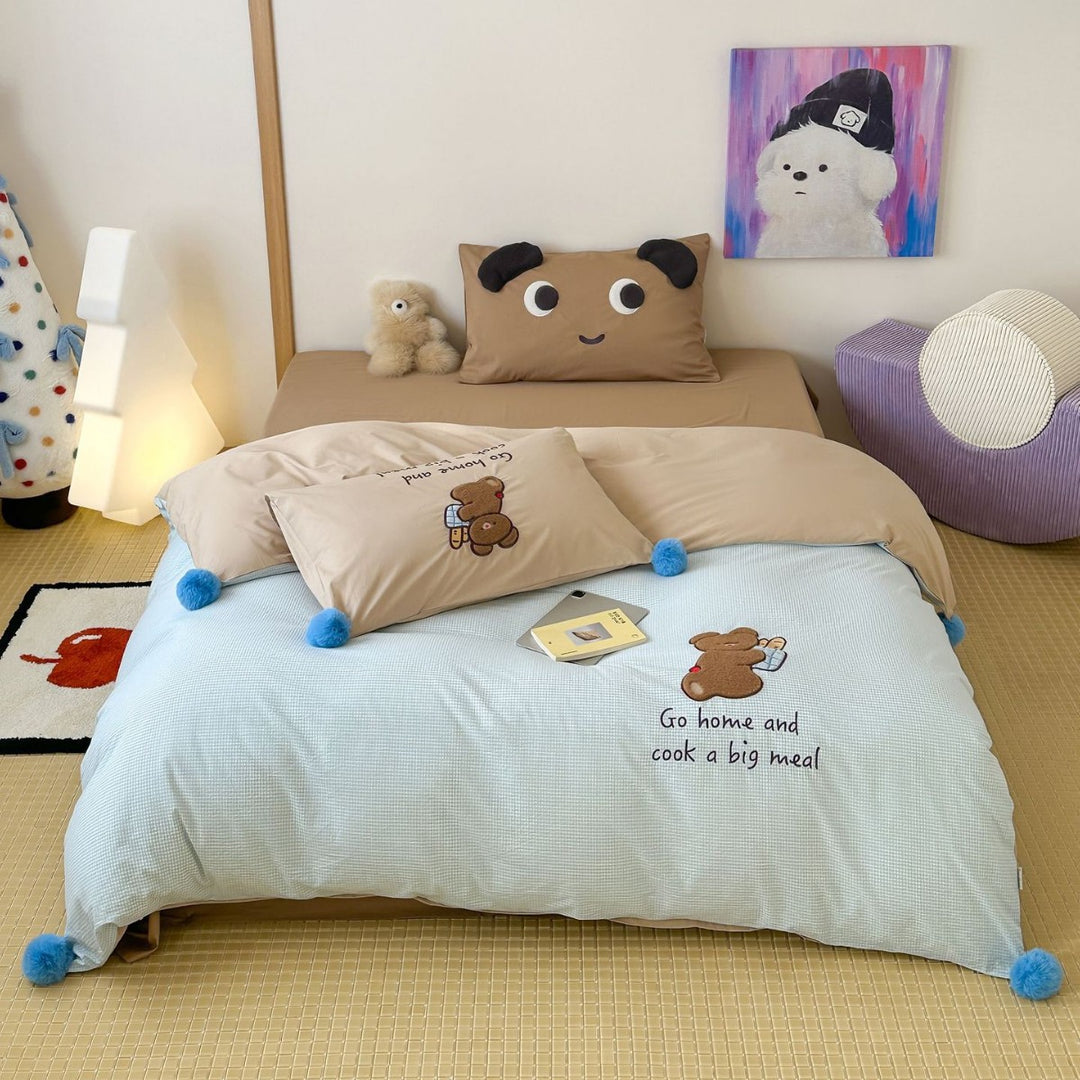 Playful cotton bedding set with pompom trim and embroidered rabbit motif