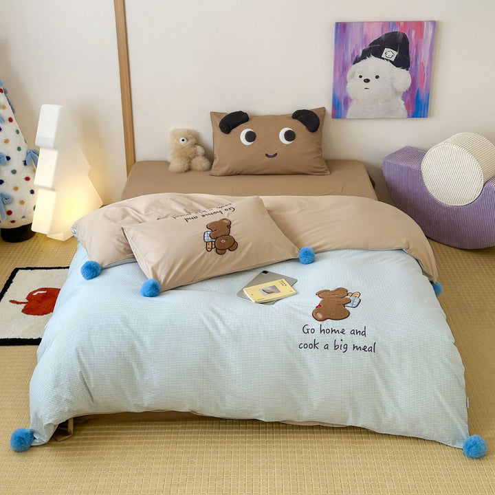 Playful cotton bedding set with pompom trim and embroidered rabbit motif